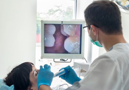 Dentist and patient looking at intraoral dental images