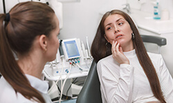 Young woman with dental hygienist for dental emergency