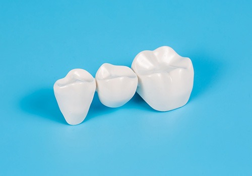 A dental bridge on a pale blue background