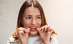 Patient putting clear aligners on in office