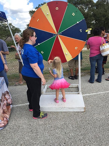 Dental team member and young child at community event