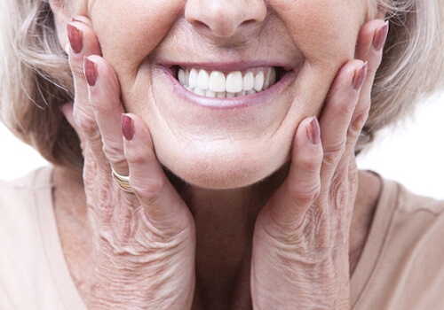 Closeup of senior woman smiling with dentures in San Antonio