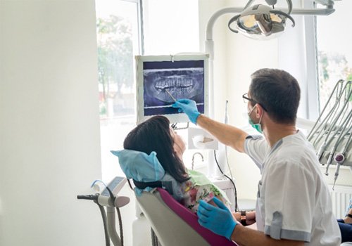 dentist showing a patient their X-rays