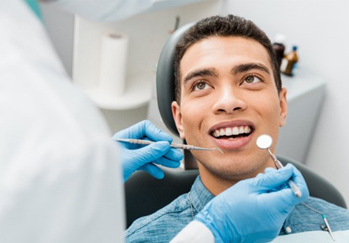 man having his teeth examined by a dentist