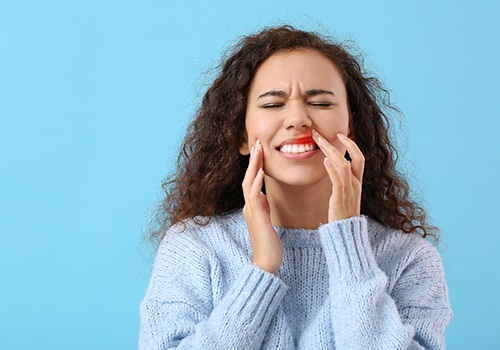 Woman in blue sweater with inflamed gums