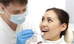 Dentist performing dental implant care in San Antonio on patient