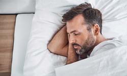 Man sleeping after dental implant surgery after dental implant surgery in San Antonio 