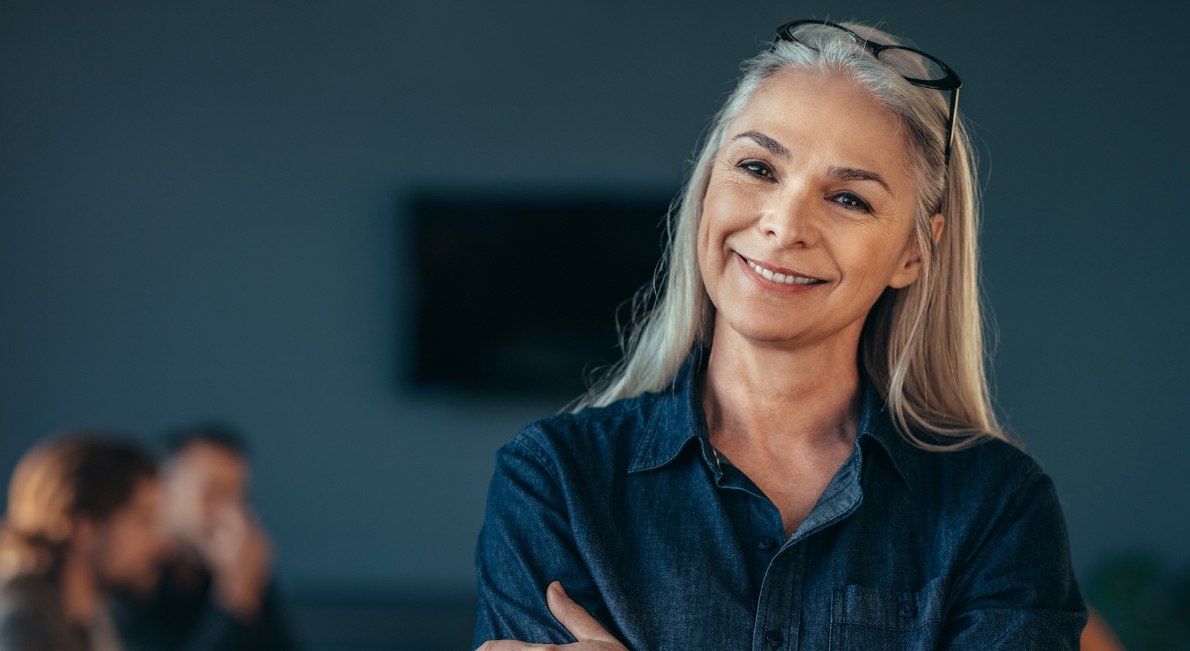 Woman in denim shirt smiling