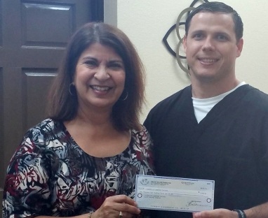 Doctor Brice smiling with dental patient in San Antonio