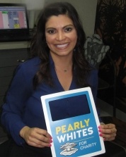 Dental patient holding up a dental charity sign