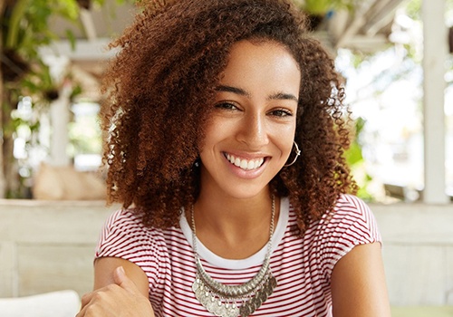 Woman smiling with straight teeth at restaurant