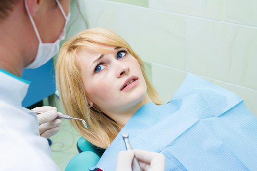 Woman afraid in the dental chair