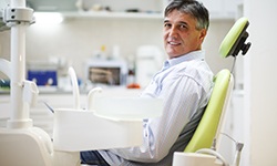 Smiling patient sitting in treatment chair