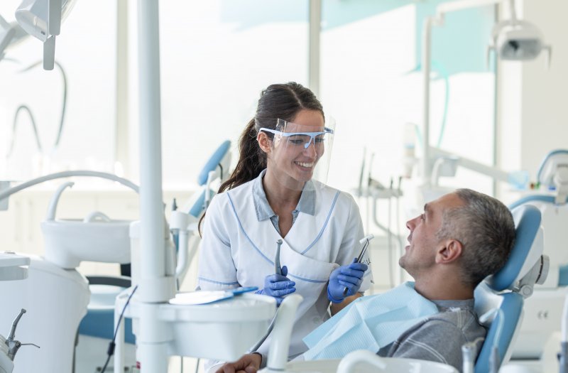 Dentist in San Antonio wearing PPE with patient