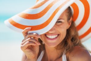 woman smiling after teeth whitening at the beach