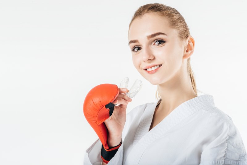 Woman holding a mouthguard