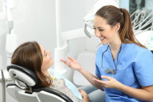 patient chatting with her dentist in San Antonio at her dental checkup 