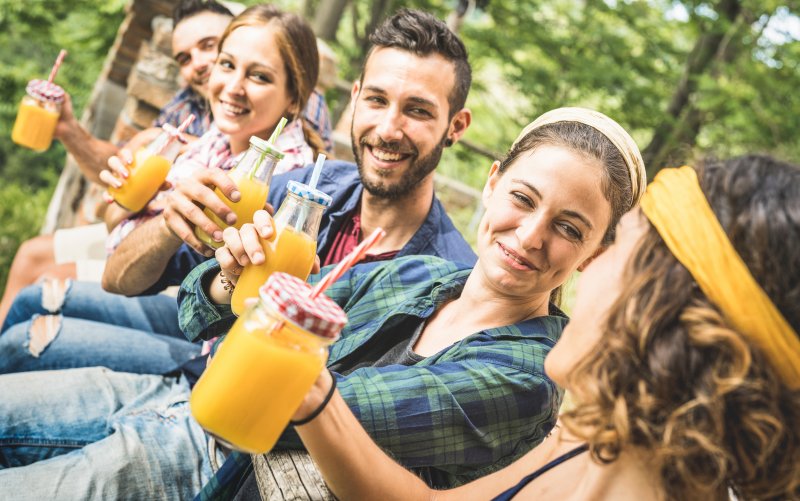 friends following diet trends by drinking fresh juice 
