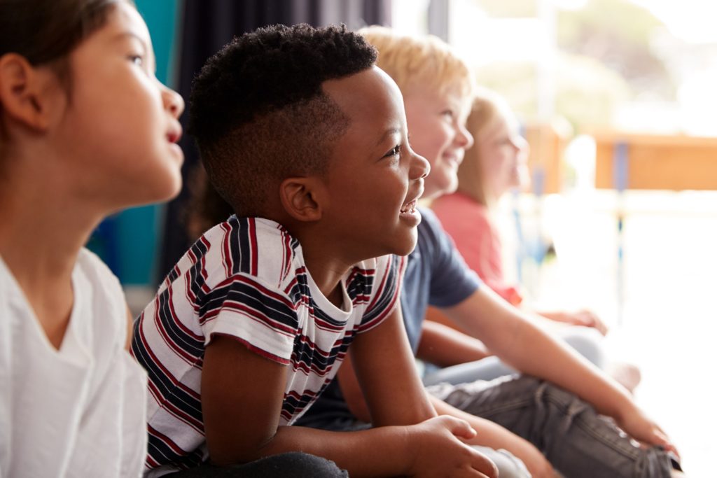 Young boy smiling in classroom