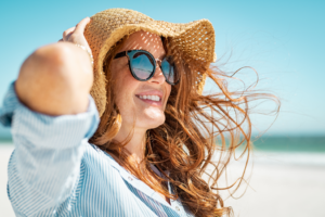 a patient showing off their smile during the summer