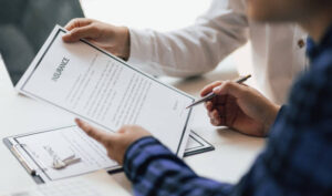 Two people reading an insurance policy