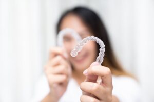Woman smiling after adjusting to Invisalign